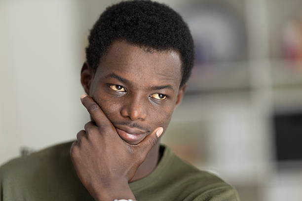 istock Young black man looking away, thinking and contemplating 2236149998