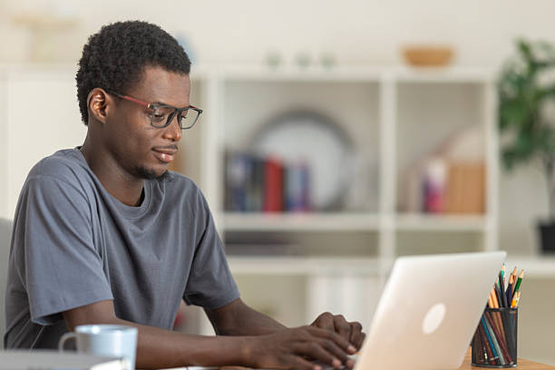 istock Focused young adult man typing on a laptop, engaged in remote work or e-learning 2236150112