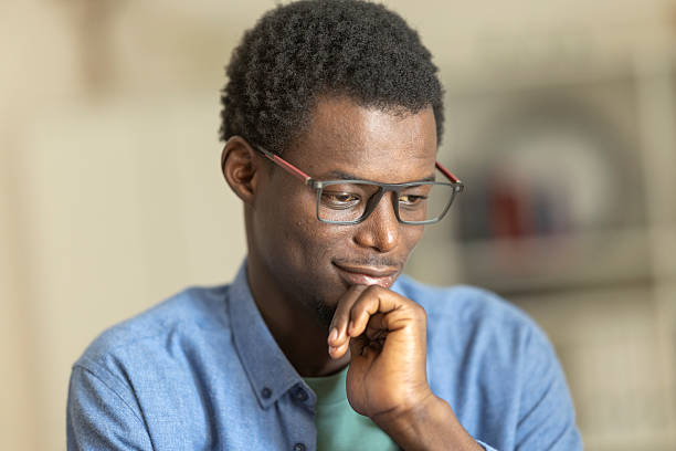 istock African american man wearing glasses, thinking and smiling 2236150120