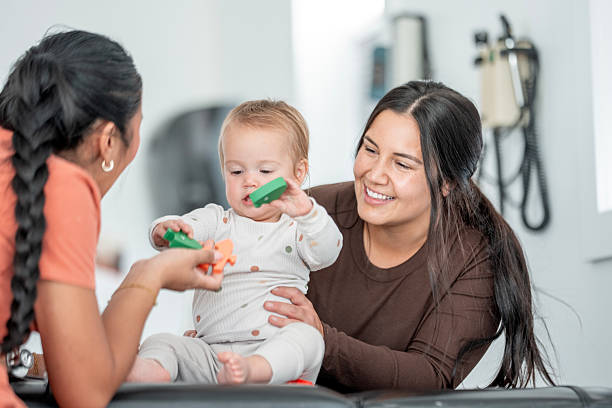 istock Diverse Women Interacting with Baby During Playtime in a Bright Medical Environment 2236152253