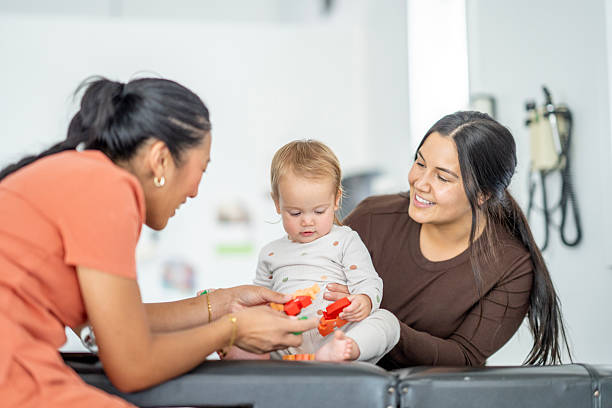 istock Caretaker and Mother Interact with Infant in Modern Indoor Setting 2236152324