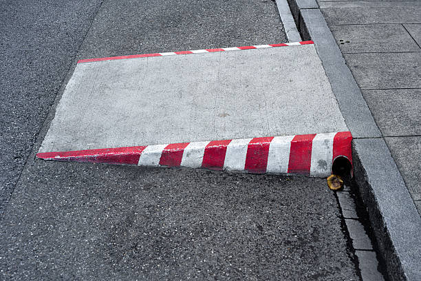 istock Concrete Ramp with Red and White Stripes on Street Corner 2236152347