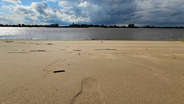 istock Harriersand Island beach with footprints and cargo ship under cloudy sky 2236153623