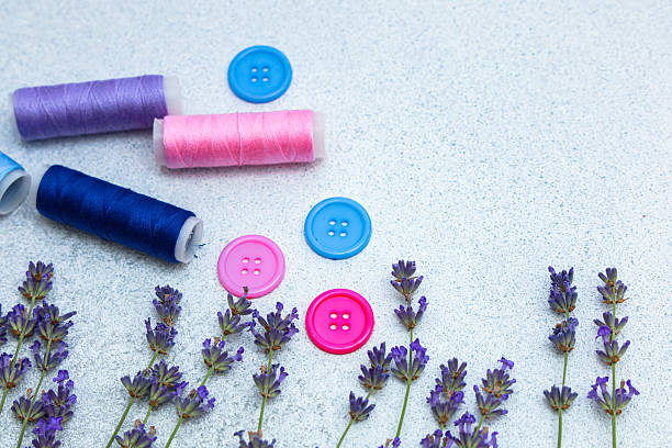 istock Colorful sewing supplies arranged with lavender on a light surface for creative crafting 2236153644