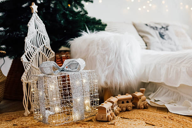 istock Festive living room with decorated Christmas tree and gift box under soft winter light 2236154537