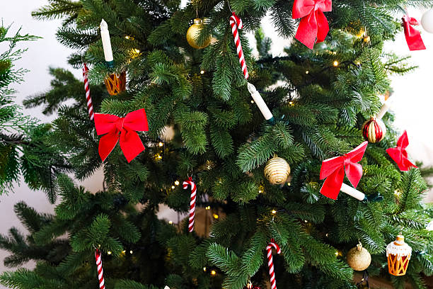 istock Decorated Christmas tree with red bows and ornaments in a festive setting 2236154645