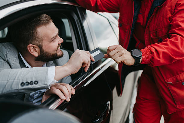 istock Driver paying for car service with credit card 2236155904