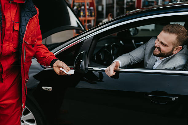 istock Mechanic checking car oil for a smiling customer 2236155907