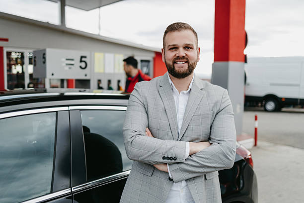 istock Confident man posing at gas station with car 2236155947