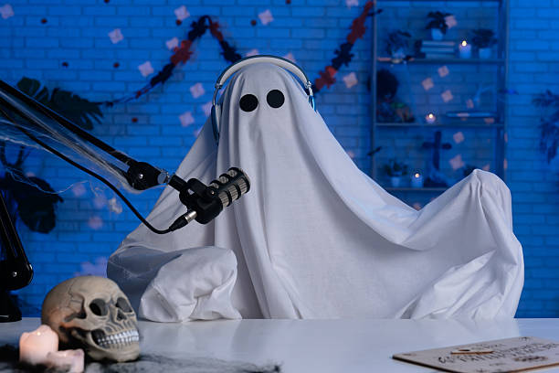 istock Ghost costume recording podcast or blog in a studio with blue light 2236159367