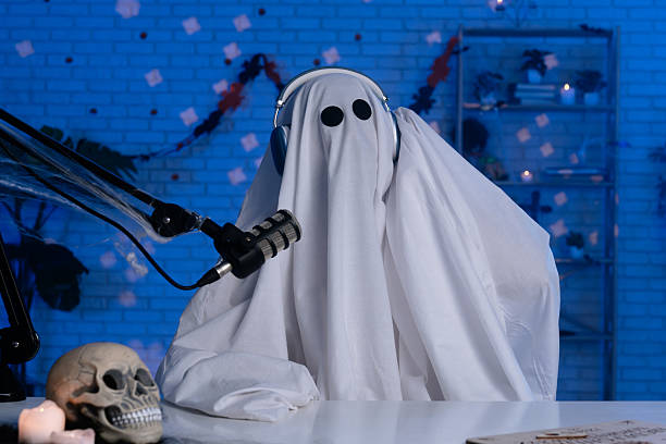 istock Ghost costume recording podcast or blog in a studio with blue light 2236159504