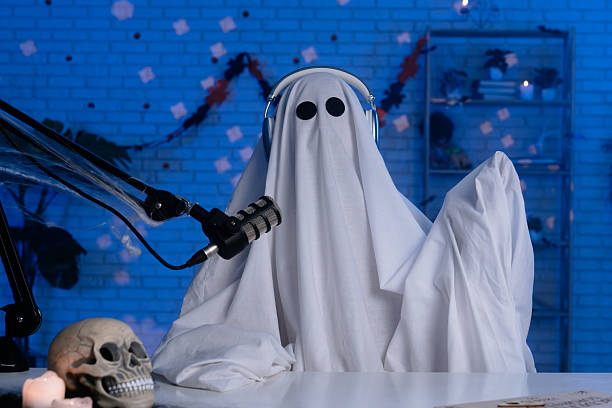 istock Ghost costume recording podcast or blog in a studio with blue light 2236159613