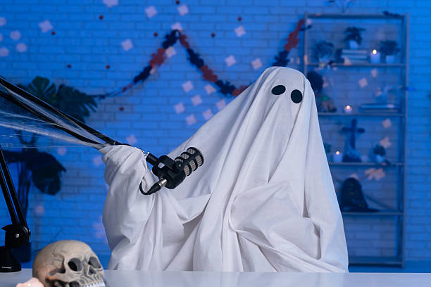 istock Ghost costume recording podcast or blog in a studio with blue light 2236159812