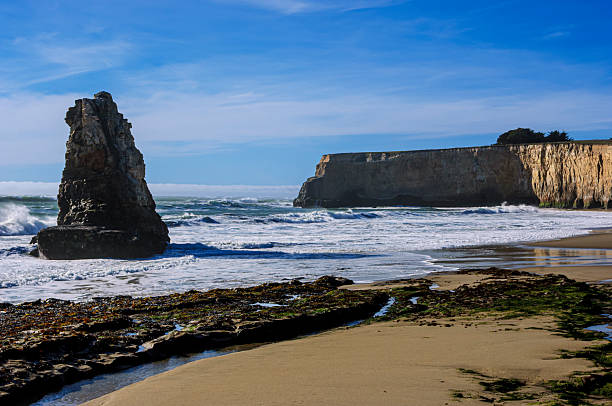 Turbulent waves crashing around a coastal sea stack off the  California coast, where a storm had just passed through.Taken at Davenport Beach, California, USA