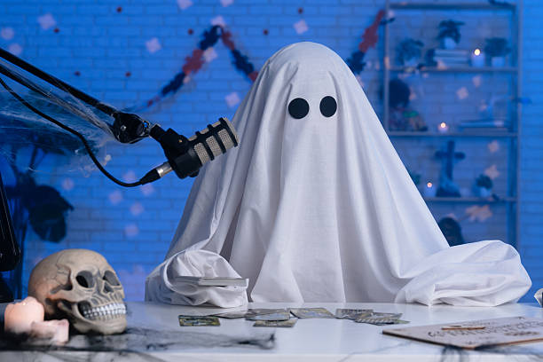 istock Ghost costume recording podcast or blog in a studio with blue light 2236160240