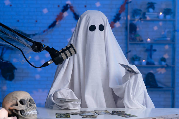 istock Ghost costume recording podcast or blog in a studio with blue light 2236160316
