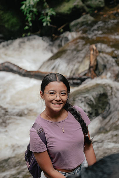 istock Smiling girl wearing glasses by a flowing river 2236167451