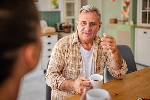 istock Senior man enjoys a warm conversation with his nurse in a cozy home setting 2236172501