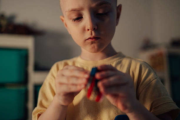 istock Young boy concentrating on building toy at home 2236173984