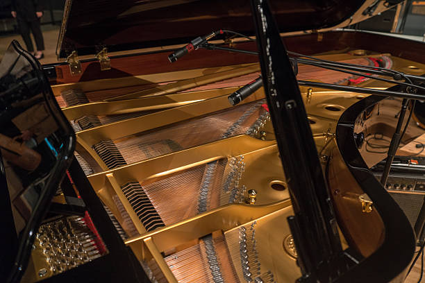 Grand piano and sound-collecting microphone on stage