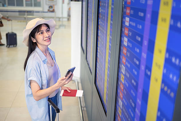 istock Traveler Checking Departure Flight Information at Airport Terminal 2236174871