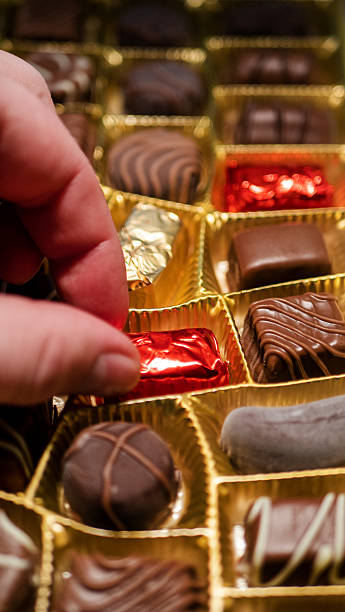istock Delicious chocolate candies in packaging background 2236175720