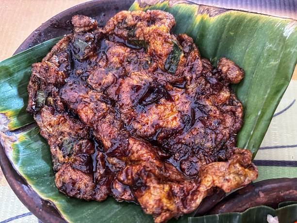istock A grilled omelet with a glossy dark brown sauce, served on a banana leaf and an earthenware plate. Showcasing a traditional Indonesian dish. 2236175743