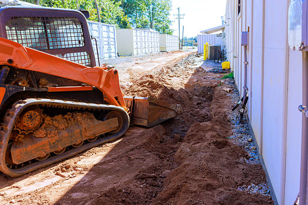 istock Excavation work in progress near building with small construction vehicle on works day 2236176621