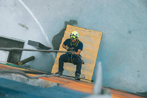 istock Firefighter rescuer descending a massive wall using a rappelling device in a multi-story building, wearing protective gear such as a helmet, harness, and carabiners. 2236176778