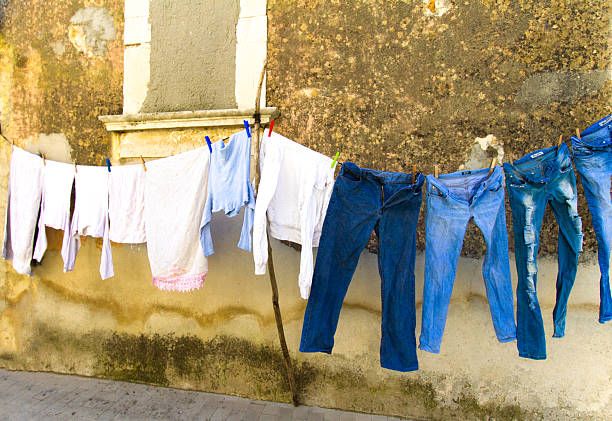 Sicily: Hanging Laundry--Blue Jeans in a Row Against Old Wall. Shot in Ragusa