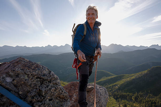istock Climber on mountain top at sunset 2236177096