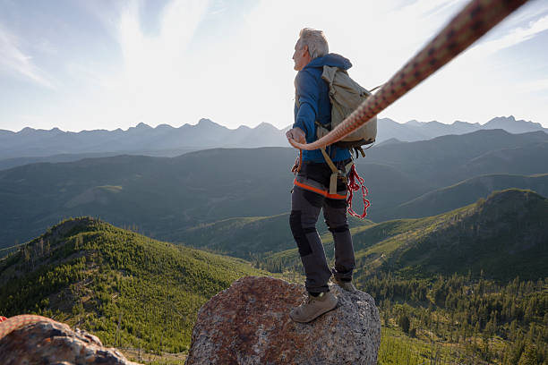 istock View down rope to climber on mountain top 2236177100