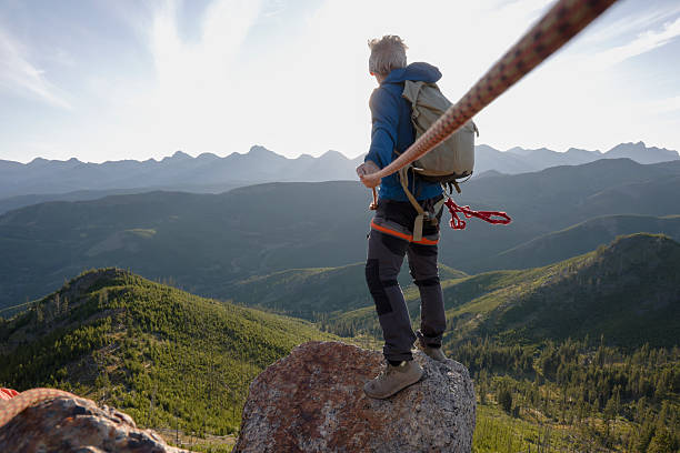 istock View down rope to climber on mountain top 2236177101