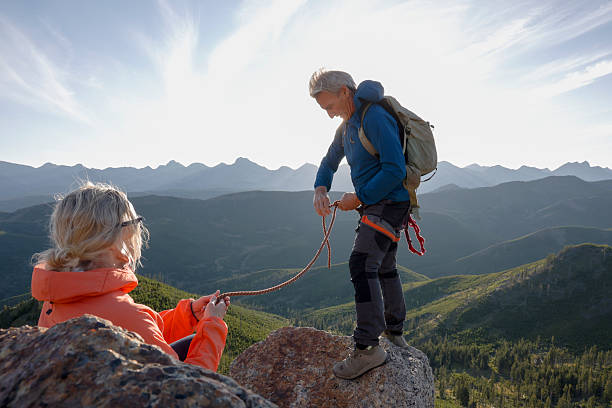 istock Mature couple climb on mountain top 2236177107