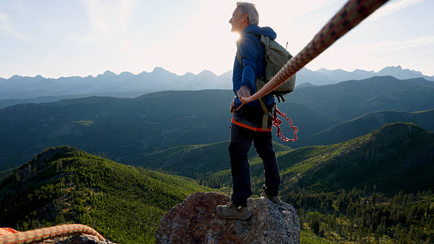 istock View down rope to climber on mountain top 2236177130