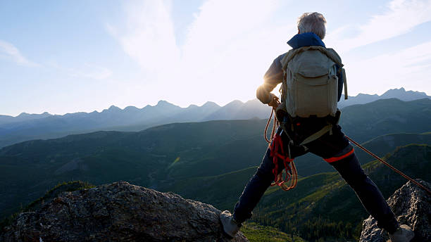 istock Climber balances bridges gap on mountain top 2236177147