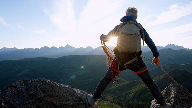 istock Climber balances bridges gap on mountain top 2236177149