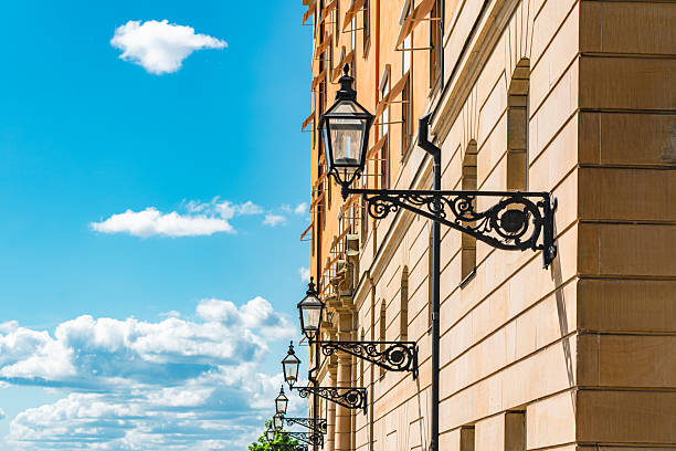 Urban architecture of a building with ornate street lanterns under a bright blue sky