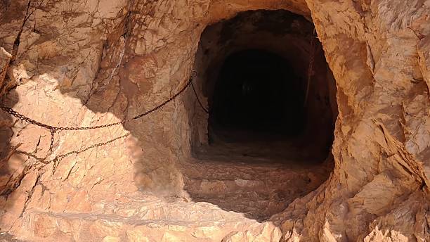 istock A mysterious tunnel entrance with chains leads deep into intriguing depths, inviting exploration 2236180885
