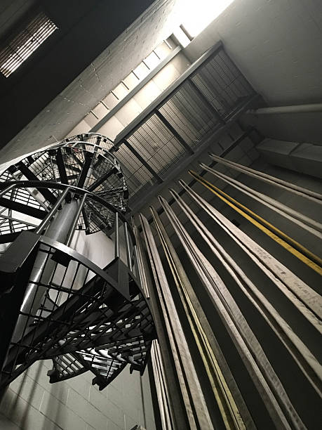 istock Looing up to the ceiling with a spiral staircase and fire hoses hanging from ceiling 2236180924
