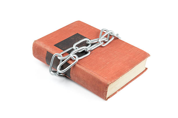 Old red book with metal chain isolated on white background with clipping path