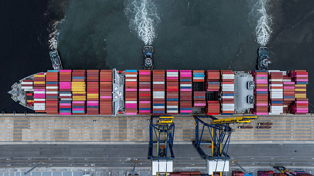 istock Aerial view container cargo ship at port with tugboat, Business global import export logistic maritime transport by container cargo ship vessel, International trade container cargo freight shipping. 2236182575