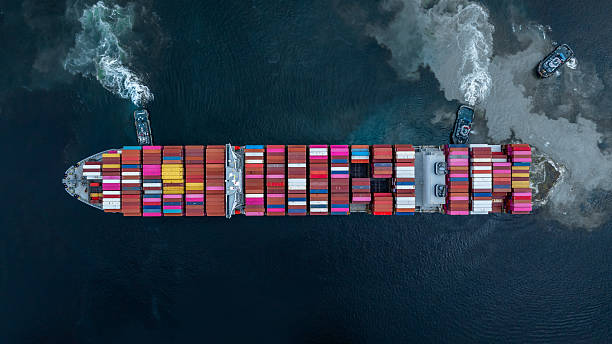 istock Aerial view container cargo ship at port with tugboat, Business global import export logistic maritime transport by container cargo ship vessel, International trade container cargo freight shipping. 2236182592