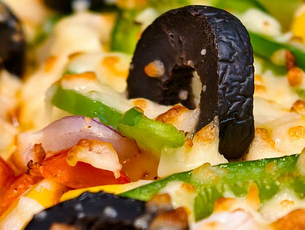 A woman eats a savory Hungarian lángos topped with mozzarella, arugula, and tomatoes. A delicious street food treat that looks just like a personal pizza.