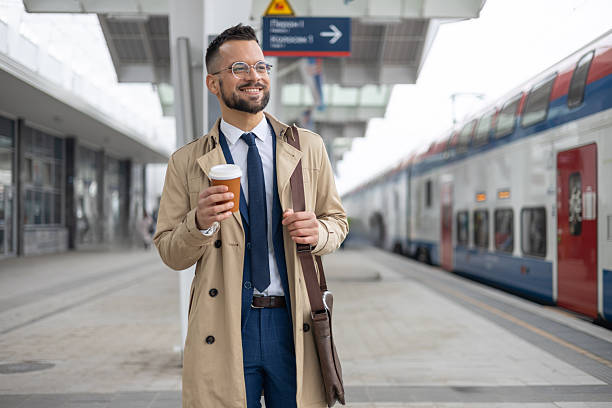 istock A male student is using holding a cup of coffee while waiting of train 2236187450