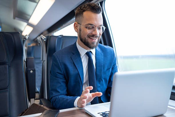 istock Young businessman having a video call while traveling by train 2236187472