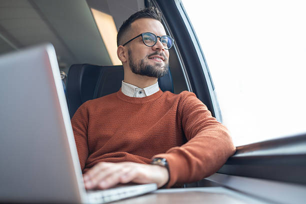 istock A male student is using laptop, looking out of the window 2236187488