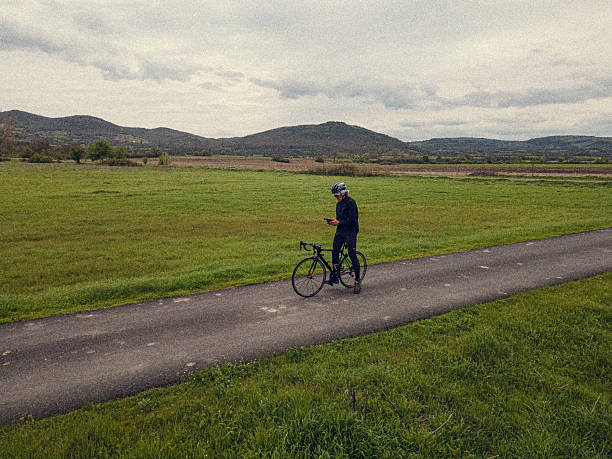 istock Cyclist Checking GPS Navigation On Dirt Road In Nature 2236187556