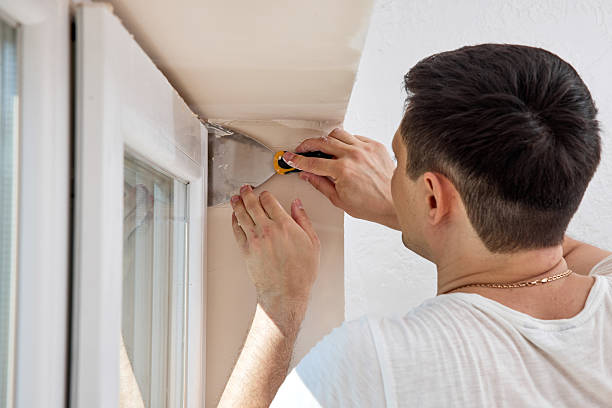 istock man with a spatula applying finishing putty on a window opening 2236187688