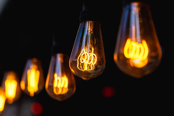 Glowing edison bulbs illuminating dark background